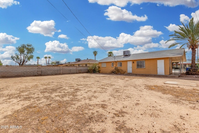 view of yard featuring central AC unit and fence