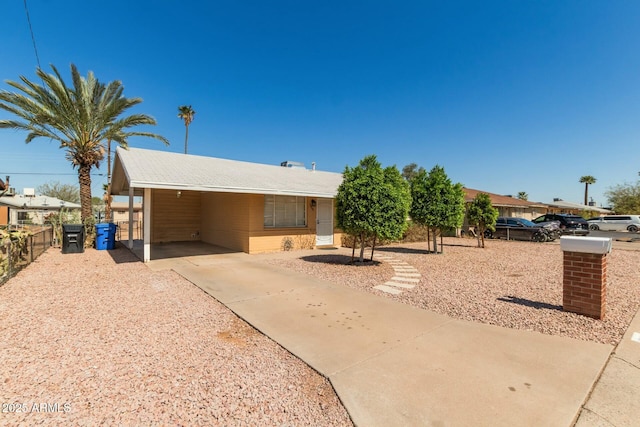 single story home with an attached carport and fence