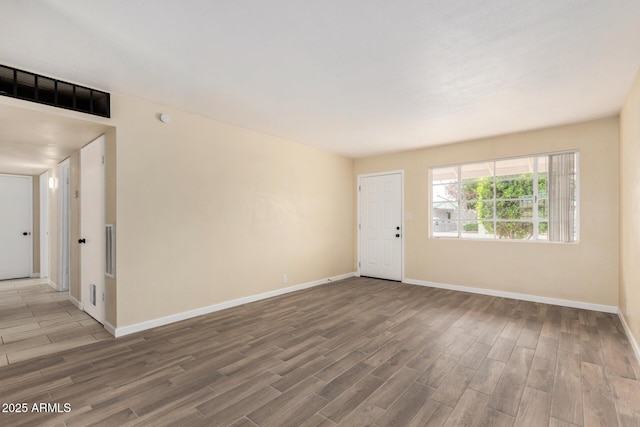 interior space featuring visible vents, baseboards, and wood finished floors