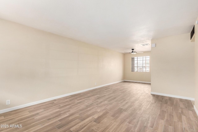 empty room featuring visible vents, baseboards, light wood-style flooring, and a ceiling fan