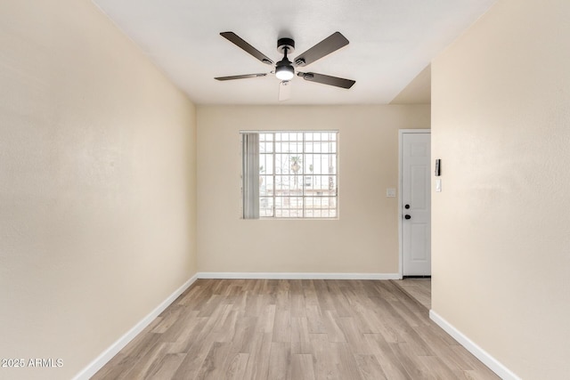 unfurnished room featuring ceiling fan, baseboards, and light wood-style floors