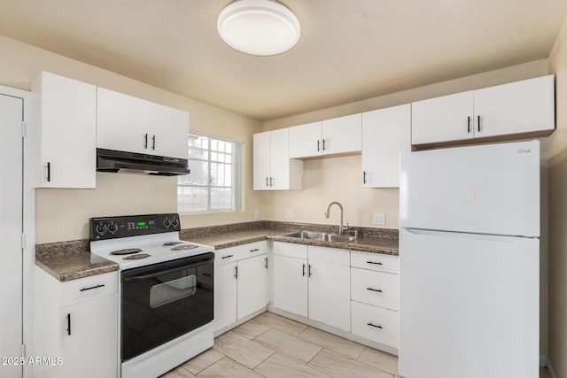 kitchen with under cabinet range hood, a sink, range with electric stovetop, dark countertops, and freestanding refrigerator