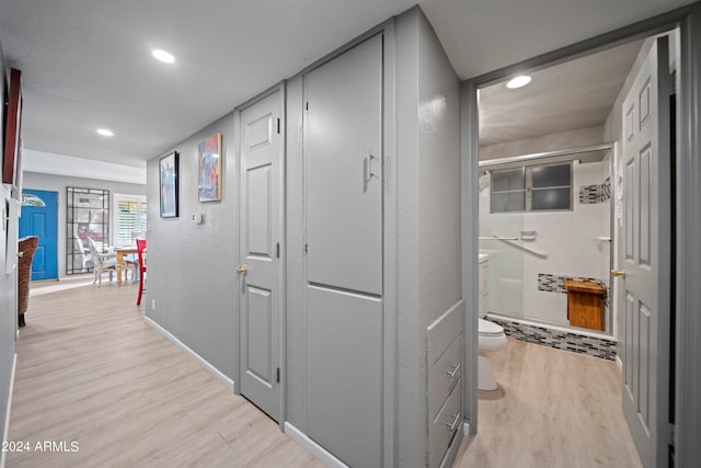 corridor with light hardwood / wood-style floors