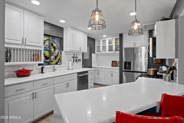 kitchen featuring white cabinets, appliances with stainless steel finishes, and a kitchen breakfast bar