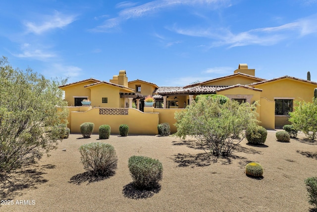 9290 E Thompson Peak Pkwy Unit 409, Scottsdale, AZ 85255 - view of front of property with a chimney, stucco siding, fence, and a tiled roof