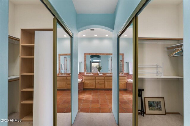 28607 N 152nd St, Scottsdale, AZ 85262 - interior space featuring arched walkways, a sink, light tile patterned flooring, and light colored carpet