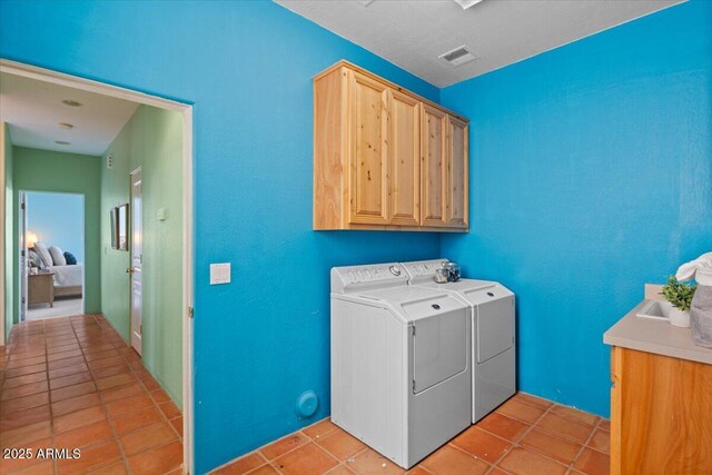 28607 N 152nd St, Scottsdale, AZ 85262 - washroom with light tile patterned flooring, visible vents, washer and dryer, and cabinet space