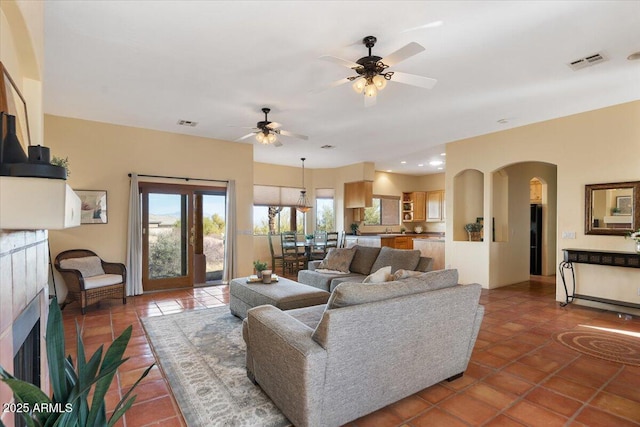 28607 N 152nd St, Scottsdale, AZ 85262 - living area featuring light tile patterned flooring, visible vents, arched walkways, and a ceiling fan