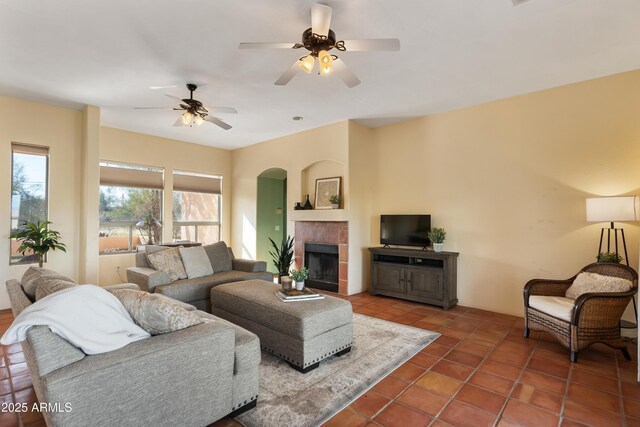 28607 N 152nd St, Scottsdale, AZ 85262 - tiled living area with a tiled fireplace, arched walkways, and ceiling fan