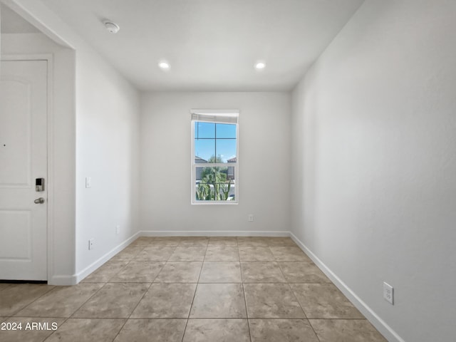 spare room with light tile patterned floors, recessed lighting, and baseboards