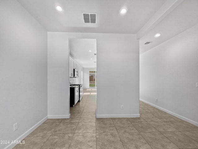 empty room featuring recessed lighting, visible vents, baseboards, and light tile patterned floors