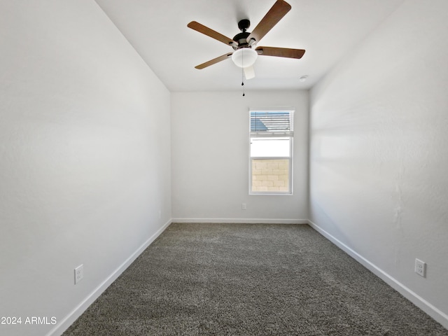 empty room with carpet floors, ceiling fan, and baseboards