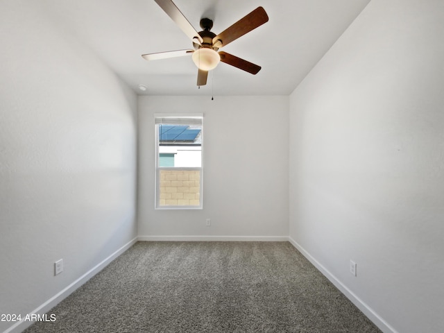 carpeted empty room with baseboards and a ceiling fan