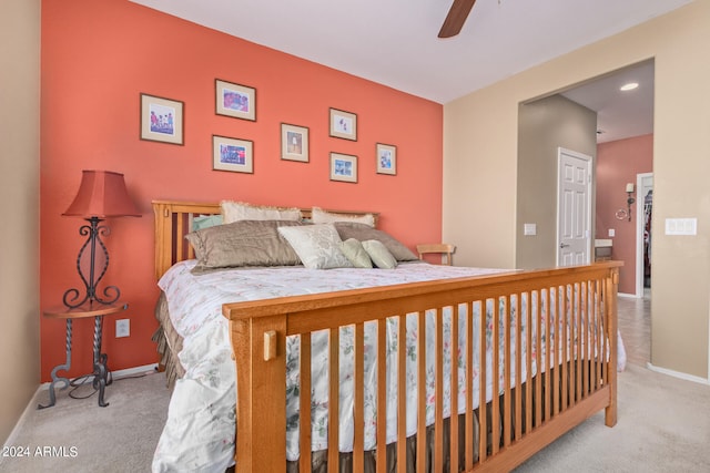 bedroom with a closet, light carpet, and ceiling fan