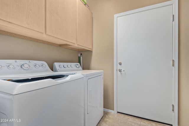 laundry room with cabinets, separate washer and dryer, and light tile floors