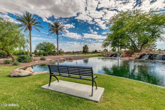 view of home's community featuring a water view and a yard