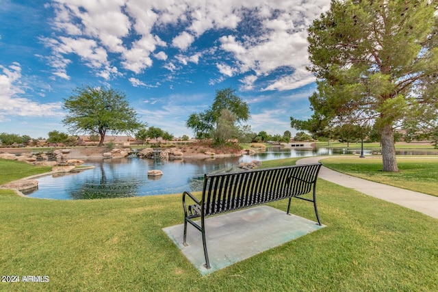 view of home's community featuring a lawn and a water view