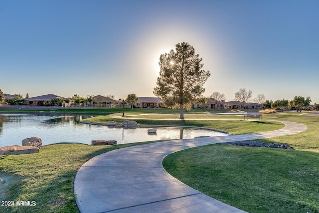 view of nearby features with a water view and a lawn