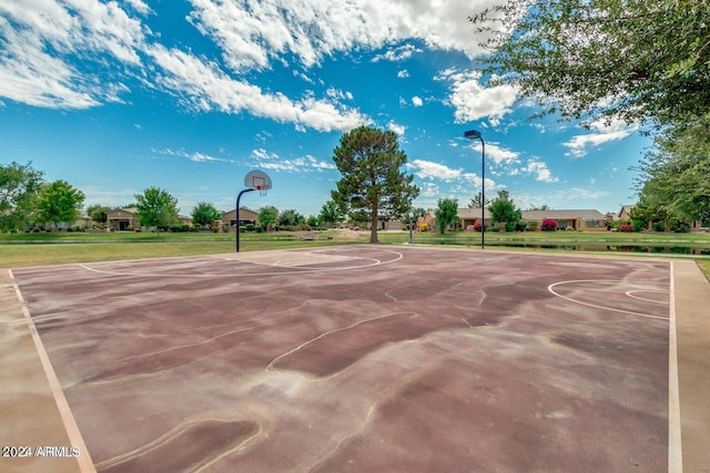 view of basketball court with a yard