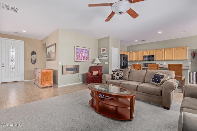 living room featuring ceiling fan and light colored carpet