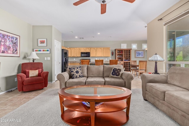 living room with light tile flooring and ceiling fan