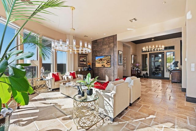 living room featuring a wealth of natural light and a notable chandelier