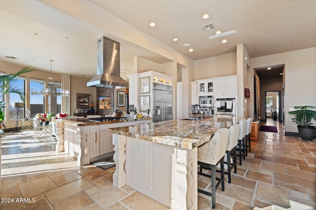 2549 W Shinnecock Way, Anthem, AZ 85086 - kitchen featuring appliances with stainless steel finishes, island exhaust hood, a sink, a large island, and recessed lighting