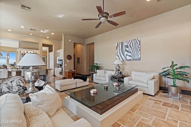 2549 W Shinnecock Way, Anthem, AZ 85086 - living area featuring recessed lighting, a ceiling fan, stone tile floors, and baseboards