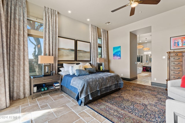 bedroom with ensuite bath and ceiling fan