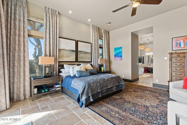 2549 W Shinnecock Way, Anthem, AZ 85086 - bedroom featuring stone tile flooring, recessed lighting, baseboards, ensuite bathroom, and ceiling fan
