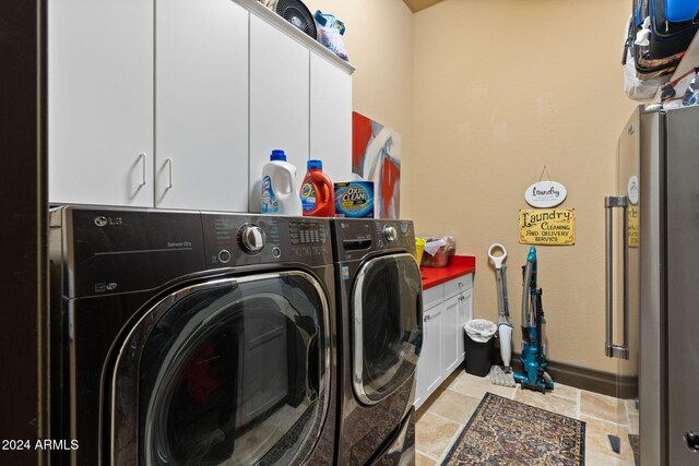 laundry room with cabinets and washing machine and dryer