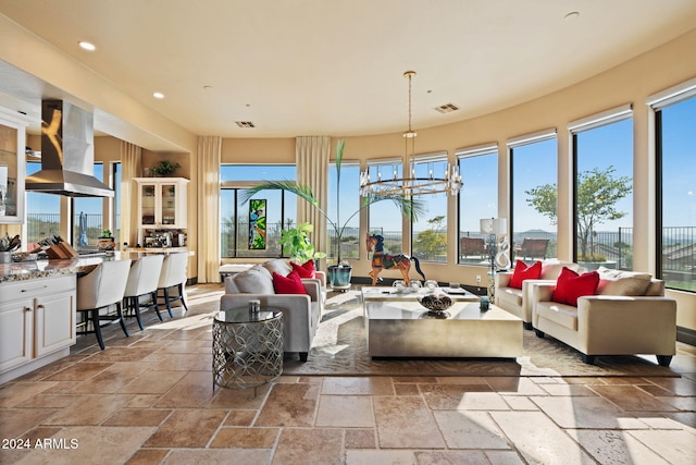 sunroom / solarium with a notable chandelier