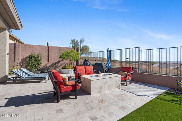 view of patio / terrace featuring an outdoor fire pit and a grill