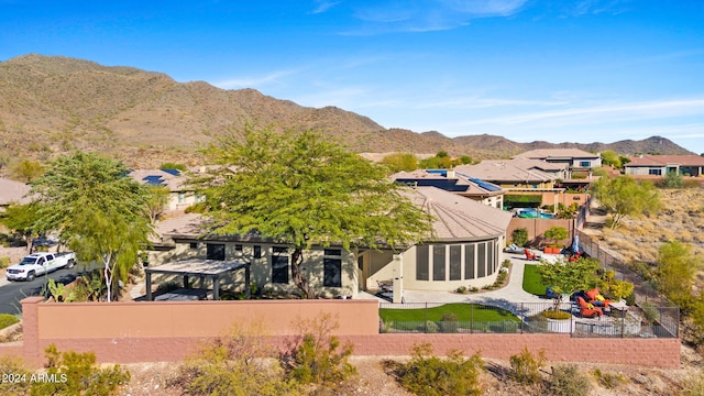 2549 W Shinnecock Way, Anthem, AZ 85086 - back of house with a fenced backyard, a mountain view, a residential view, and stucco siding