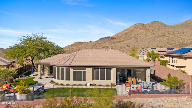 back of house featuring a mountain view and a patio area