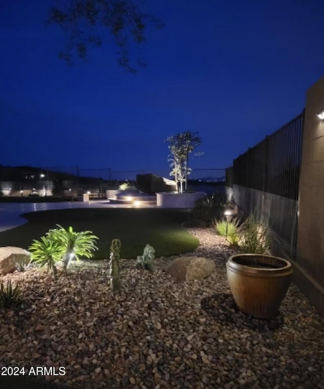 view of yard at twilight