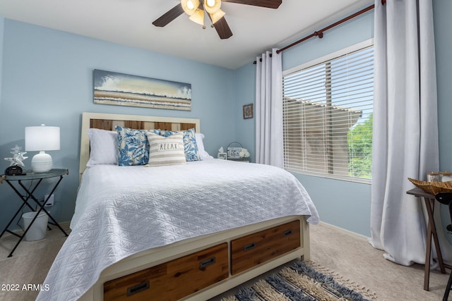 carpeted bedroom with multiple windows and ceiling fan