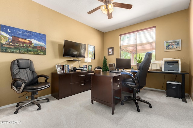 carpeted office space featuring ceiling fan