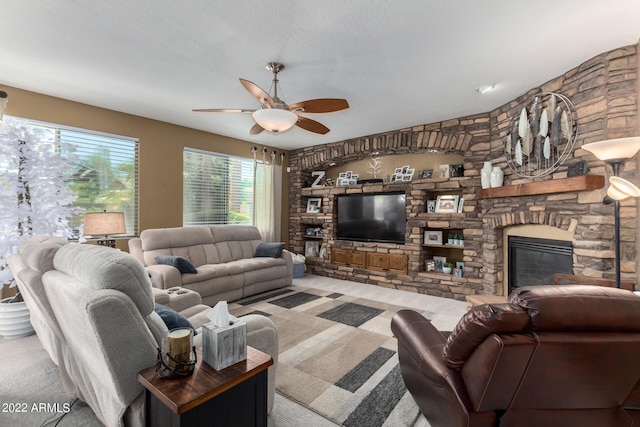 living room with ceiling fan, light colored carpet, and a stone fireplace