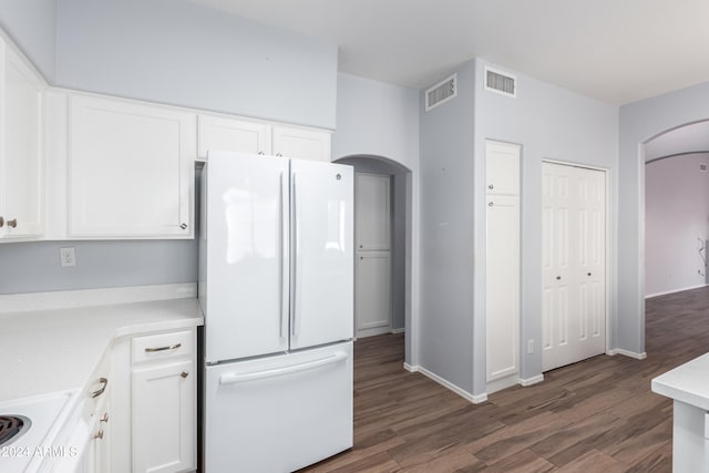 kitchen featuring dark wood-type flooring, white cabinetry, and white appliances