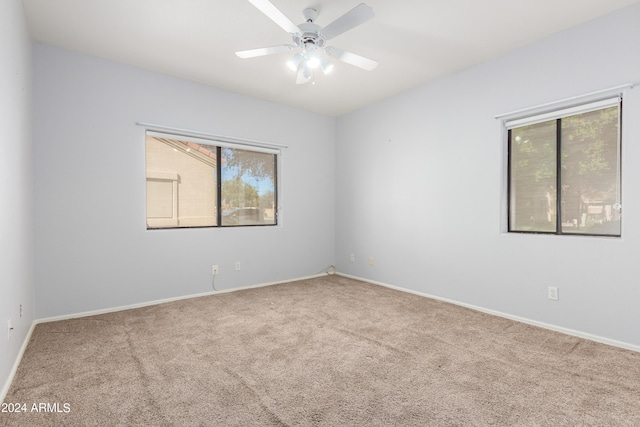 unfurnished room with carpet and ceiling fan