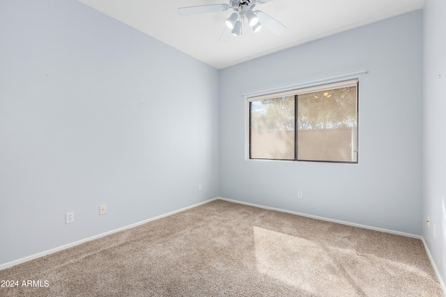 carpeted spare room with ceiling fan