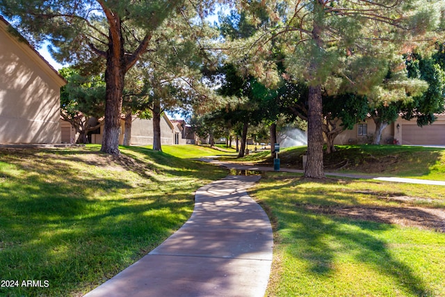 surrounding community featuring a yard and a garage