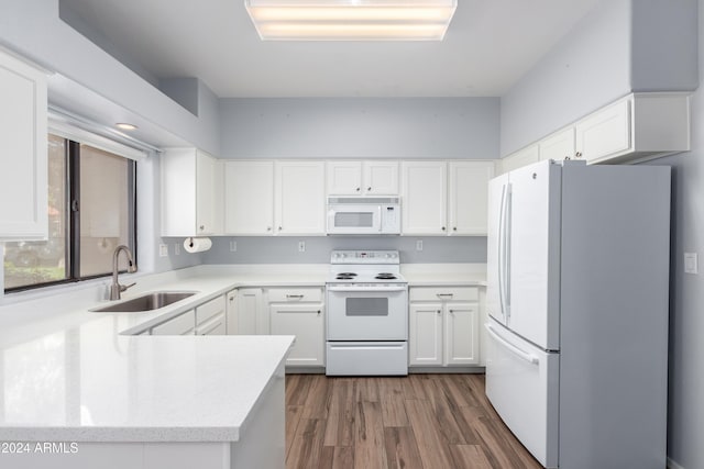 kitchen featuring dark hardwood / wood-style floors, white cabinetry, sink, and white appliances