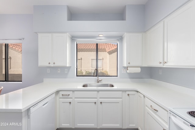 kitchen with sink, white cabinets, kitchen peninsula, and white appliances