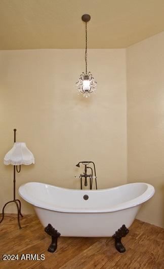 bathroom featuring hardwood / wood-style flooring and a tub