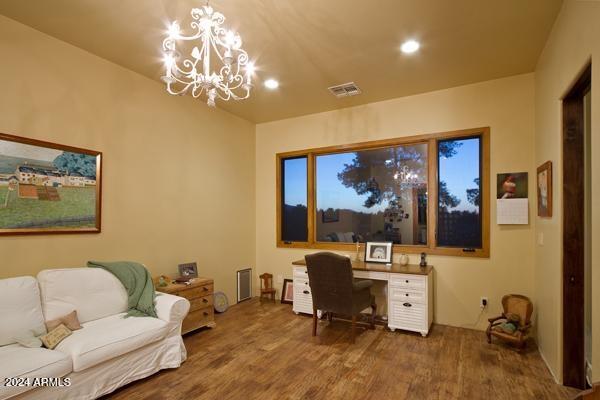 office with an inviting chandelier and hardwood / wood-style floors