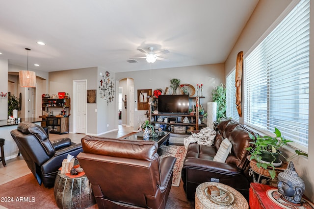 tiled living room featuring ceiling fan