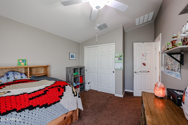 bedroom with ceiling fan, dark colored carpet, a closet, and vaulted ceiling