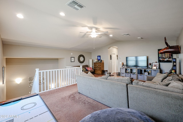 living room with ceiling fan, carpet flooring, and vaulted ceiling